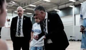 Coach giving instructions to players during a game at Caledonia Gladiators.